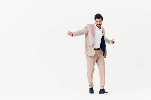 cheerful man beige success stylish business suit happy studio jumping smile smiling work running model businessman person victory male shirt winner - Foto, afbeelding