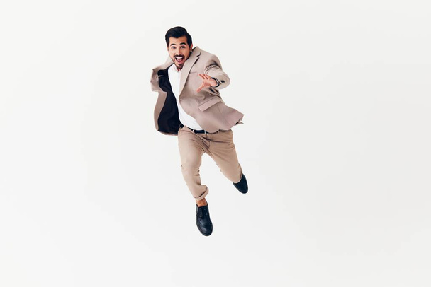 beard man confident winner businessman running happy beige flying arm young isolated smiling model background suit professional business studio smile victory - Photo, Image
