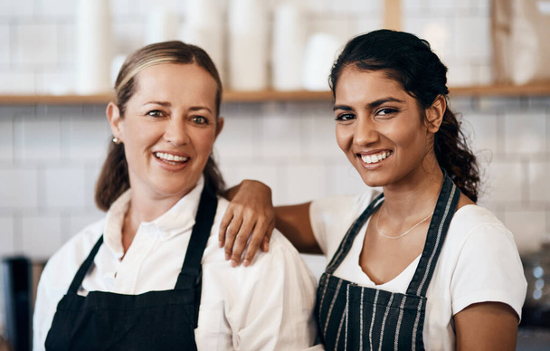 Well keep your coffee coming. Portrait of two confident women working together at a cafe - Fotoğraf, Görsel