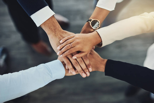 Hands together, business people and solidarity with top view, support and team huddle with collaboration. Group of employees working in office, teamwork and mission with workforce and hand stack. - 写真・画像