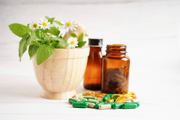 Alternative medicine herbal organic capsule with vitamin E omega 3 fish oil, mineral, drug with herbs leaf natural supplements for healthy good life. - 写真・画像