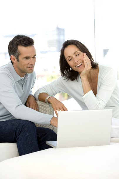 Middle-aged couple using pc at home - Photo, Image