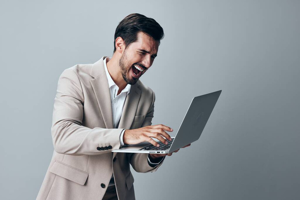internet man online freelancer vrolijk lachende man met behulp van pak copyspace business wit baan glimlach ondernemer computer geïsoleerde laptop beige werkshirt - Foto, afbeelding