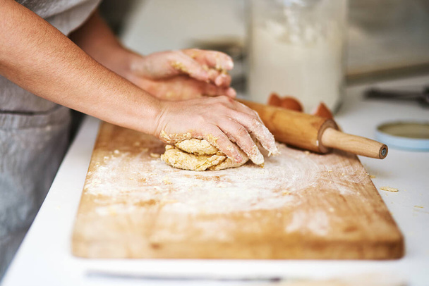 Nothing can make a house smell better than freshly baked goods. an unrecognizable woman forming a ball of dough - Photo, image