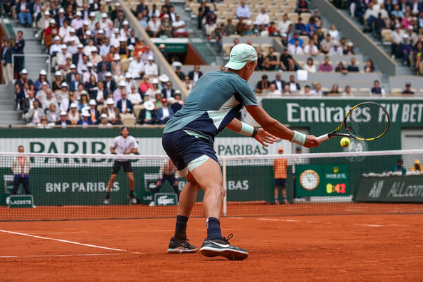 PARIS, FRANCE - MAY 30, 2022: Professional tennis player Holger Rune of Denmark in action during his round 4 match against Stefanos Tsitsipas of Greece at 2022 Roland Garros in Paris, France - 写真・画像