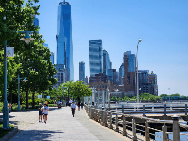 Movement of people in New York. May 17, 2023, New York, USA: Heavy movement of people and tourists in the neighborhoods of Chelsea and along the Hudson River, Statue of Liberty, which is the bustling financial heart of the city - Photo, image