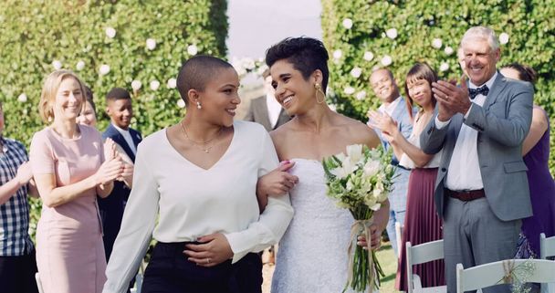 Wedding, happiness and interracial lesbian couple walking down aisle with smile, love and applause. Lgbt marriage, celebration and happy women at ceremony or reception with lgbtq pride and commitment. - Fotoğraf, Görsel