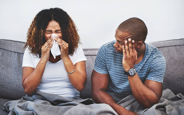 Im I going to sick now too. a young man getting irritated by his girlfriend suffering with allergies at home - Foto, immagini