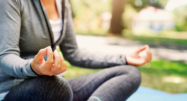 Woman outdoor, yoga and meditation with lotus pose, fitness in park with zen and spiritual healing. Female person hand, exercise in nature and meditate for health with wellness and mindfulness. - Foto, imagen