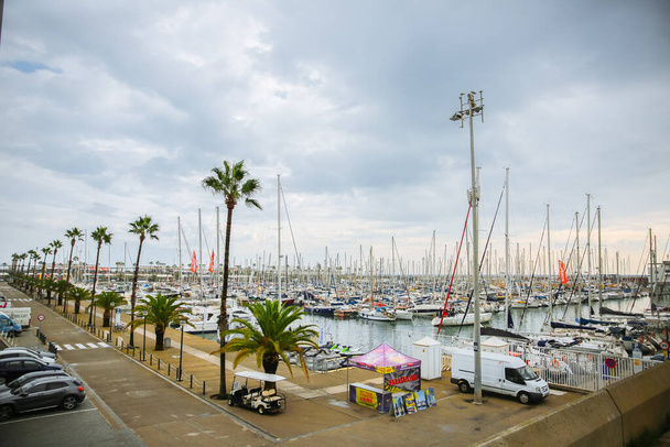 BARCELONA, SPAIN - OCTOBER 15, 2018: Port with yachts in Barcelona. Grey sky at the seaside. Ships. Touristic places. - 写真・画像