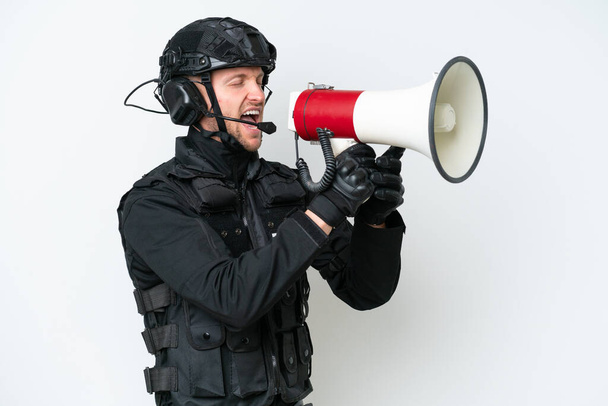 SWAT man over isolated white background shouting through a megaphone - Foto, Imagem