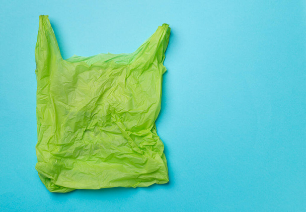 Disposable plastic bag on color background, top view. - Фото, изображение