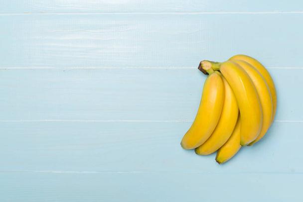 Fresh bananas on wooden background, top view - Photo, Image