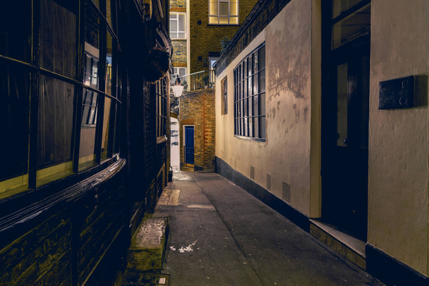 A mysterious and hidden old back alley in London at night - Фото, зображення