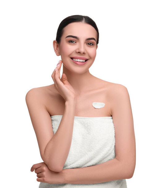 Beautiful woman with smear of body cream on her chest against white background - Φωτογραφία, εικόνα