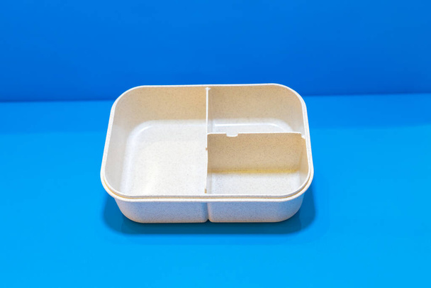 The White Lunch Box with Brown Lid and Three Compartments is a stylish and practical food storage solution. - Photo, image