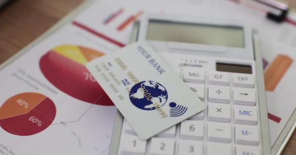 Grafici aziendali calcolatrice carta bancaria sul tavolo. Conto bancario di sviluppo finanziario e statistiche - Filmati, video