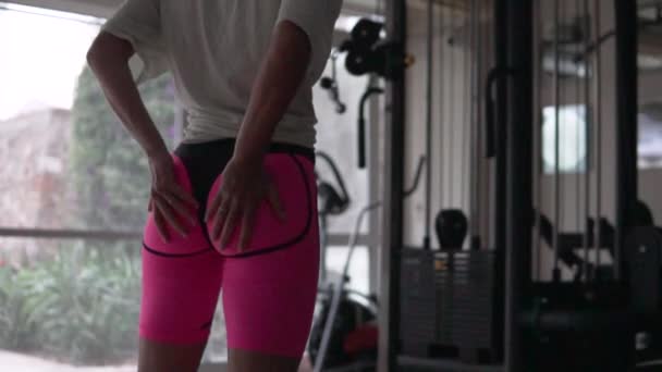 The sight of a saddle, a woman in the gym touches her big elastic inflated butt. - Filmati, video