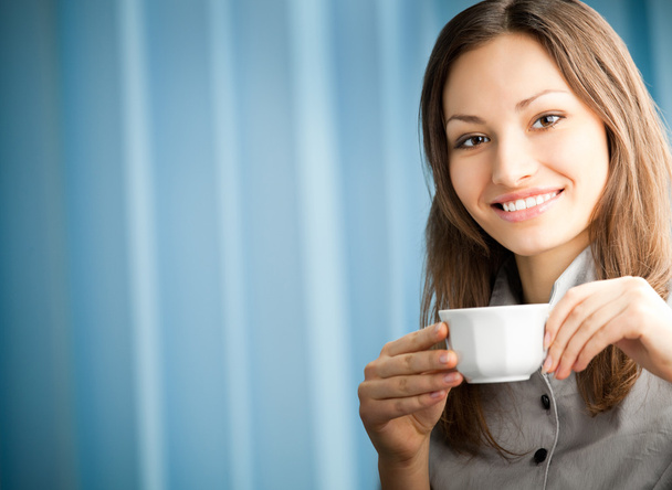 Portrait of beautiful young happy smiling businesswoman drinking - Photo, image