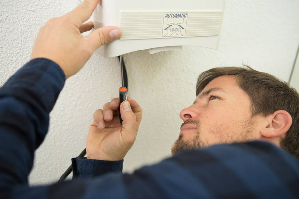 electrician fitting a thermostat system - Fotoğraf, Görsel