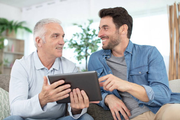senior father and young son with tablet - Photo, Image
