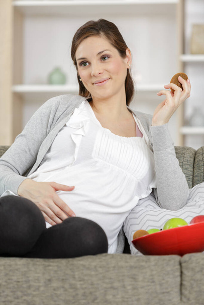 pregnant woman is holding fresh fruit - healthy eating - Photo, Image