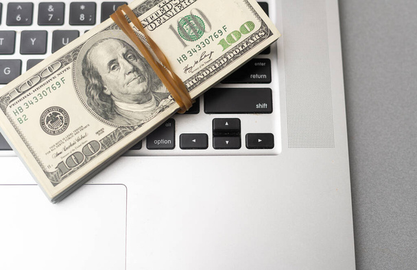 Business And Finance Concept Of Dividend Money On Laptop Keyboard. - Zdjęcie, obraz