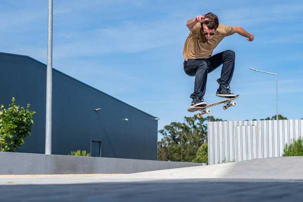 Skateboarder doing ollie trick on a urban scene. - Fotó, kép