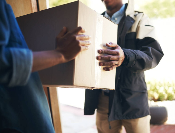 Woman, man and front door with package, delivery or ecommerce service for logistics, sale or cargo at house. Girl, box and hands for supply chain, customer experience or courier for mail at apartment. - Photo, Image