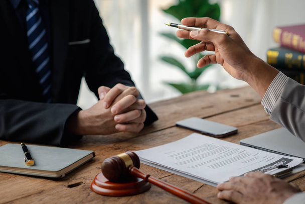 Client was listening to a lawyer advising on an embezzlement case, explaining the details of the proceeding and gathering evidence to file a lawsuit against the defendant. The concept of litigation. - Photo, image