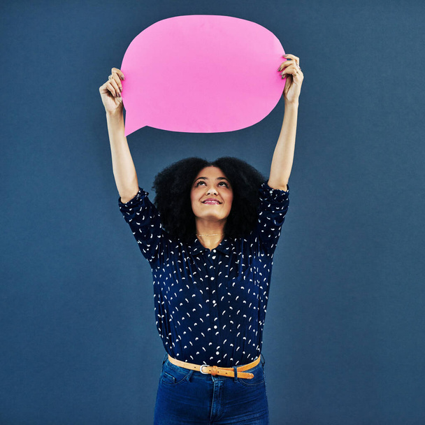 Speech bubble, mockup and woman in studio with banner for news, social media or advertising on blue background. Space, billboard and female person with paper, poster or branding, launch or promotion. - Foto, afbeelding