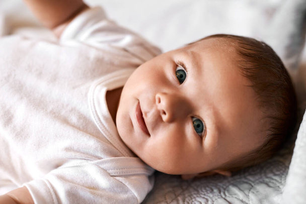 Meet Mr Adorable. an adorable baby boy lying down on a bed at home - Foto, Imagem