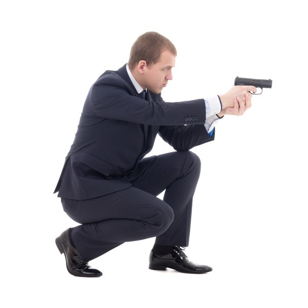 homme agent spécial en tailleur assis et le tir avec arme à feu - Photo, image