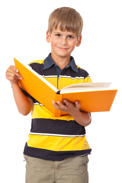 School boy is holding a book - Фото, изображение