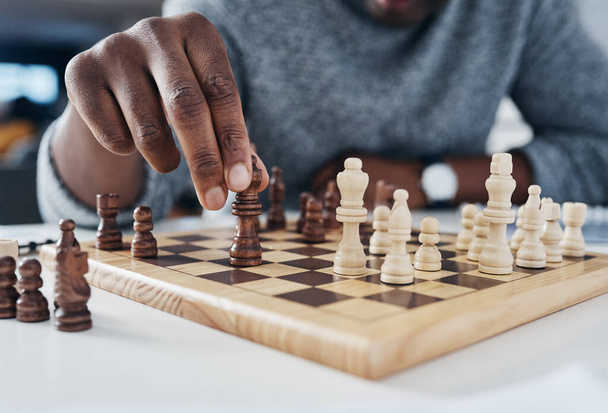 Closeup, hands and man playing chess, strategy and thinking with pieces, concentration and challenge. Zoom, male person and player with a game, hobby and activity for fun, recreation and chessboard. - Fotografie, Obrázek