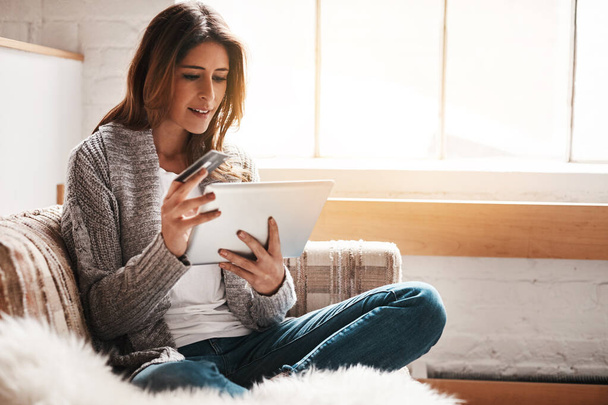 Bank, tablet and credit card with a woman online shopping on a sofa in the living room of her home. Ecommerce, finance payment and fintech banking with a young female online customer in her house. - Foto, Imagen