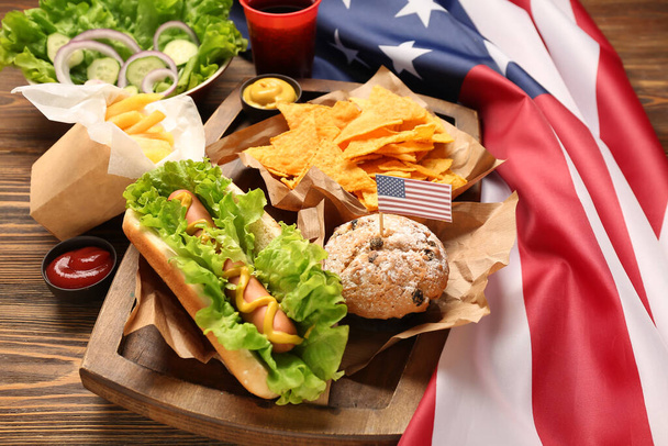 Composition with tasty dishes for Memorial Day celebration and American flag on wooden background, closeup - Photo, Image