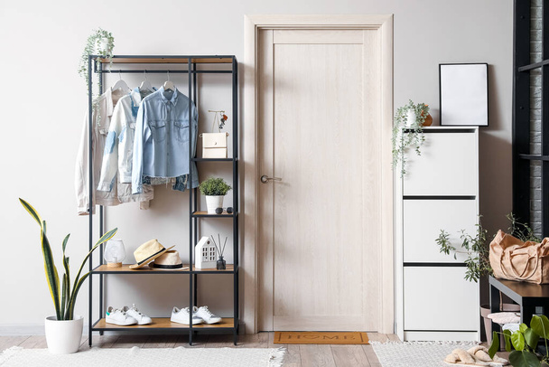Interior of modern hall with shelving unit, clothes and drawers - Фото, изображение