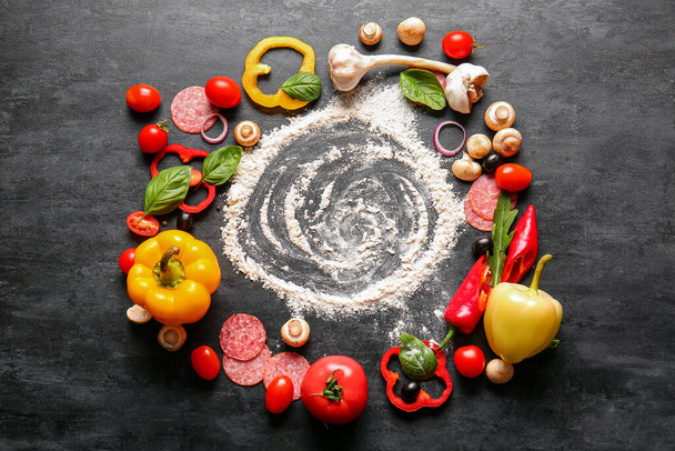 Flour and ingredients for preparing pizza on black background - Фото, зображення