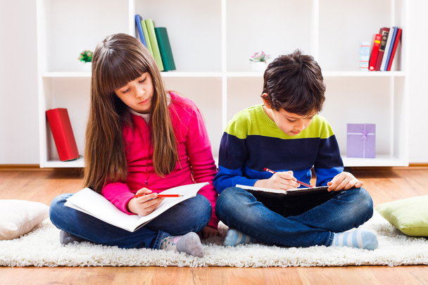 Girl and little boy are doing their homework - Foto, Imagem