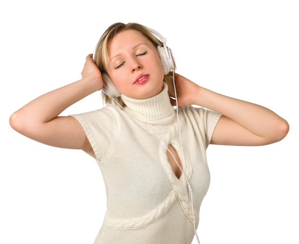 A young girl listens to music on headphones - Фото, изображение