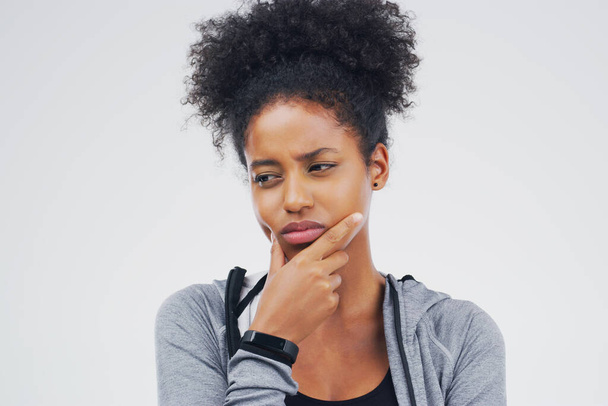 Isolated, black woman and serious thinking of workout idea, fitness or planning exercise and health goals. Girl, think or plan decision for training, gym or remember sport ideas on white background. - Photo, Image