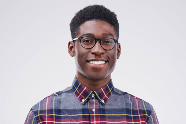 Smile, portrait of black man with glasses and happy against a white background. Nerd or geek, happiness and African male smiling with proud facial expression against a studio backdrop for confidence. - Foto, Imagen