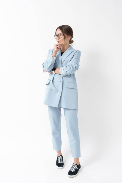 Young caucasian woman, professional entrepreneur standing in office clothing, smiling and looking confident on white background. Full length portrait - Zdjęcie, obraz