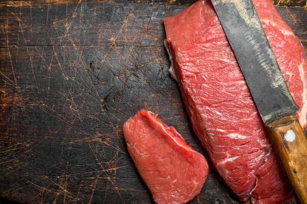Raw meat.A piece of marbled beef . On a wooden background. - 写真・画像