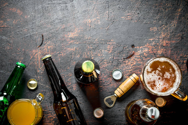 Beer in bottles and glasses. On rustic background - Fotoğraf, Görsel