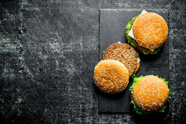 Burgers with juicy beef . On rustic background - Valokuva, kuva