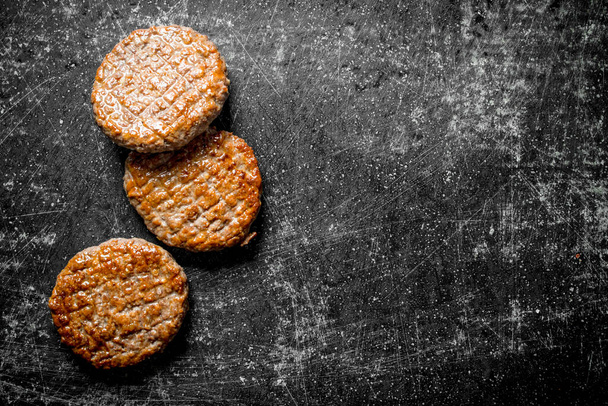 Fried meat cutlets. On rustic background - Photo, Image