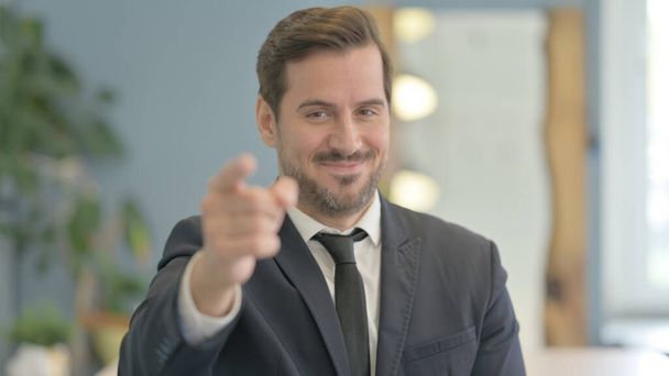 Portrait of Businessman Pointing at Camera - Photo, image