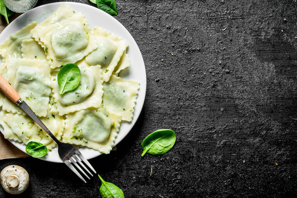 Ravioli with beef on a plate. On black rustic background - Photo, Image